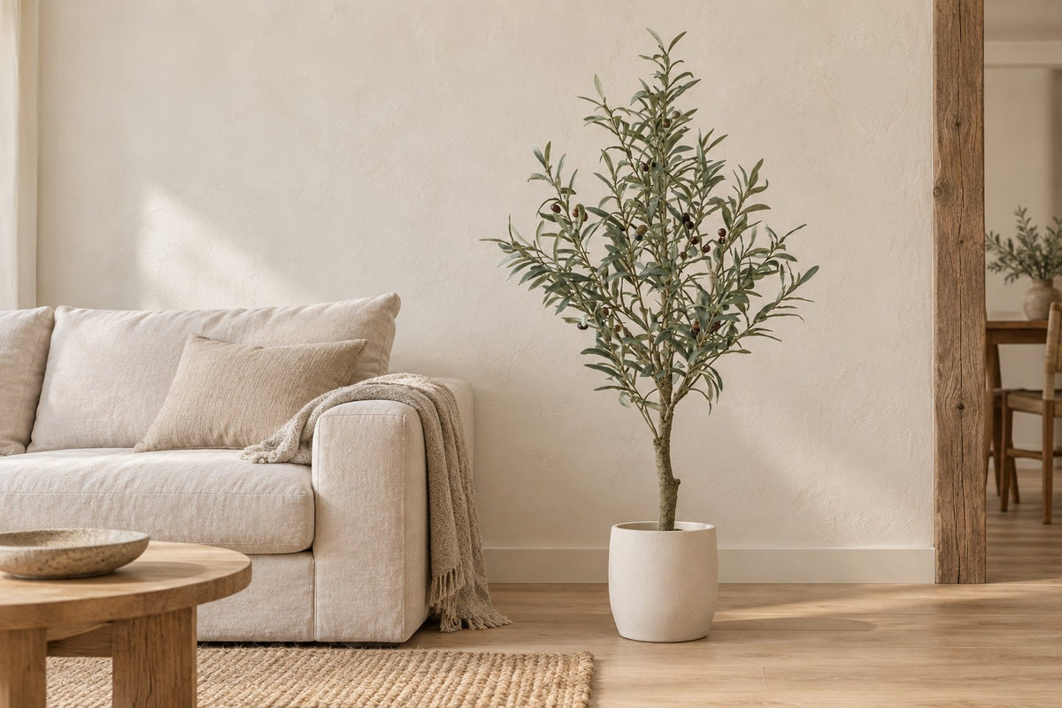 Artificial olive tree, 117 cm, in a white ceramic planter in a bright living room